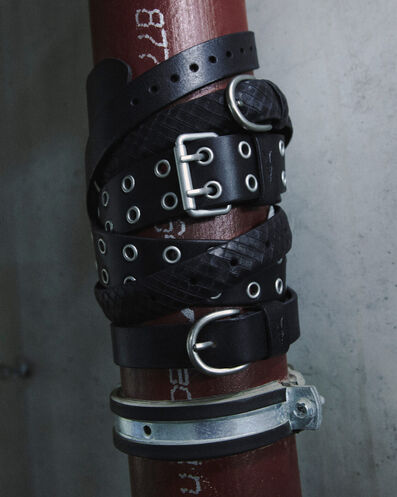 Close up of their black leather belts