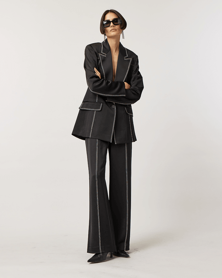 Woman Wearing Black Tailored Suit With White Stitching