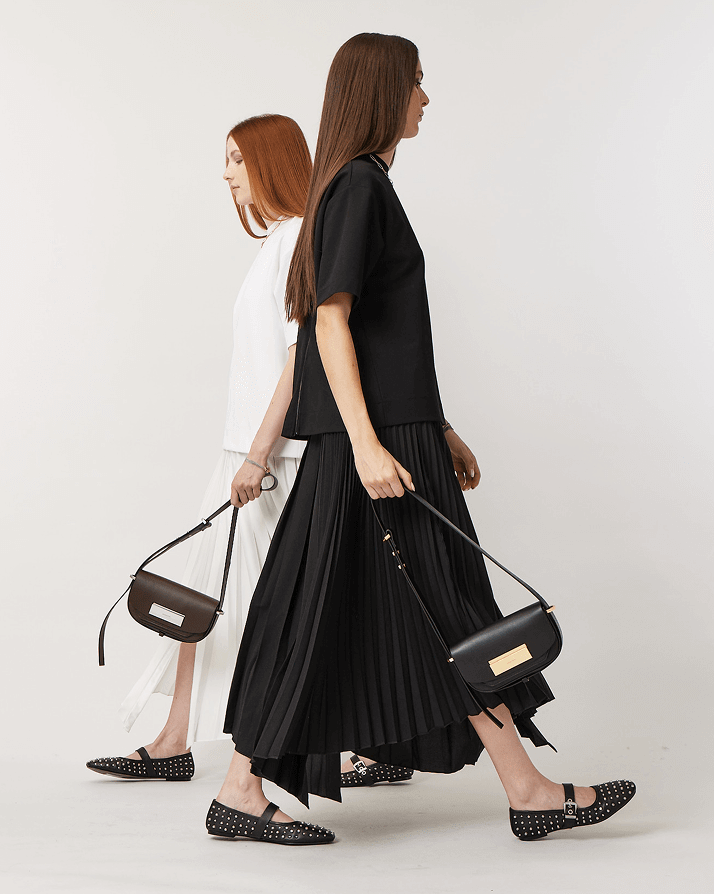 Two Woman Walking in Opposite Directions with Matching T-Shirt and Midi Skirt in Black and White