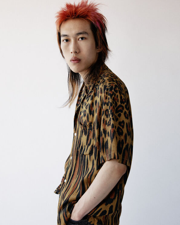 Fynn wearing a leopard print shirt