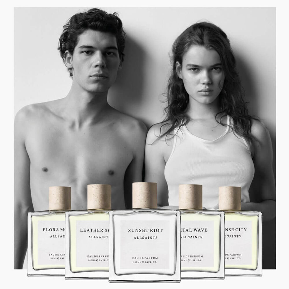 Old perfume campaign showing the 5 fragrances in front of two models