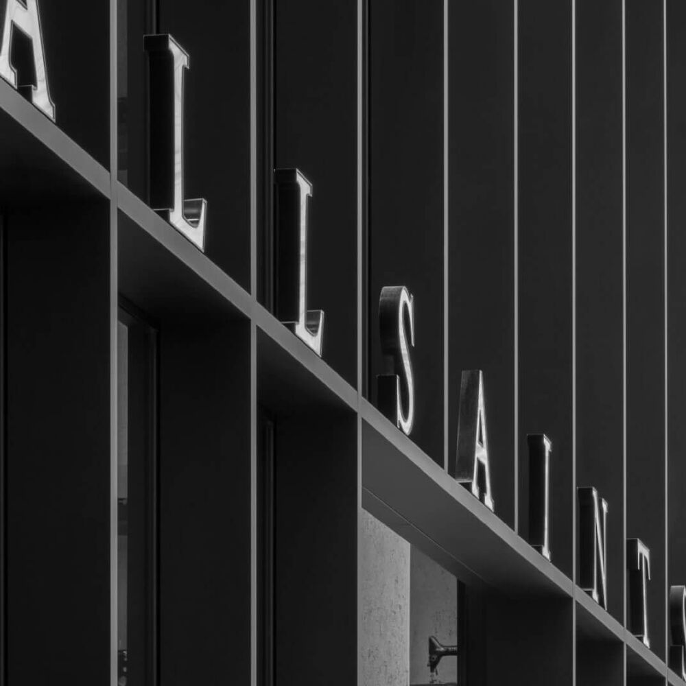 Zoom on the AllSaints logo over a stores entrance