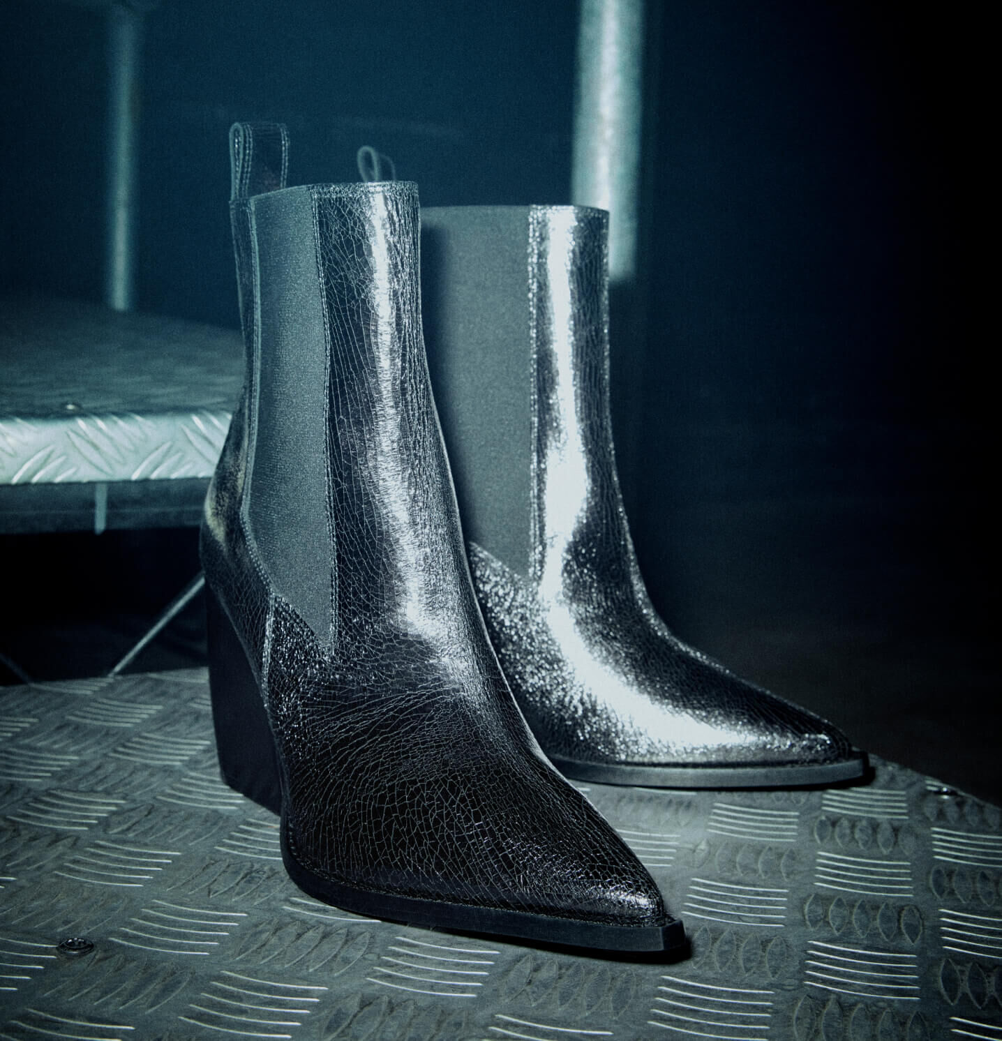 Close up on a pair of heeled black leather boots