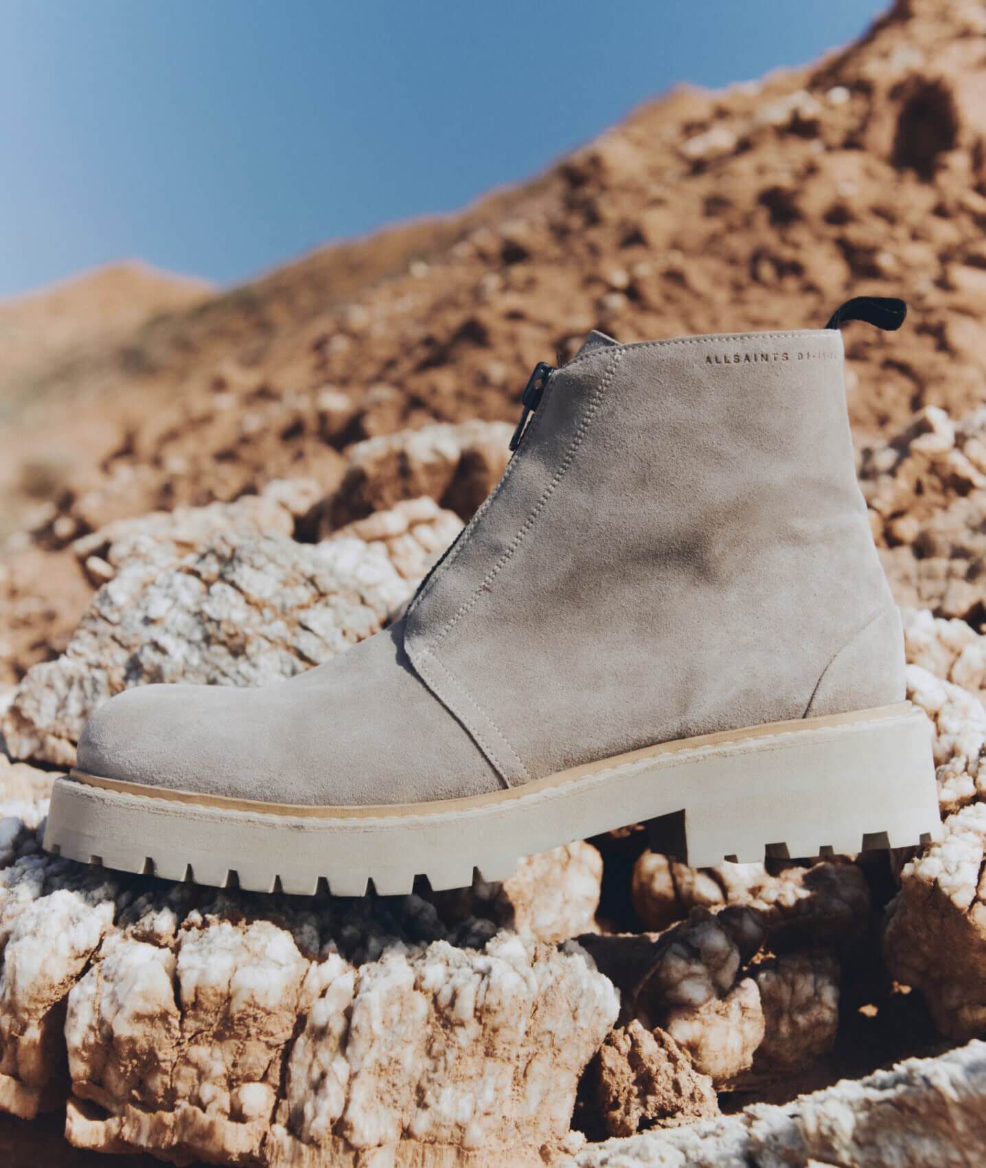 Closeup of a grey suede desert boot.
