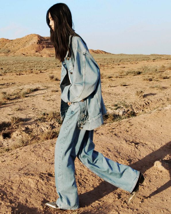 Women wearing jeans and a jean jacket. 