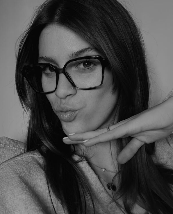 Black and white headshot of a women with glasses on